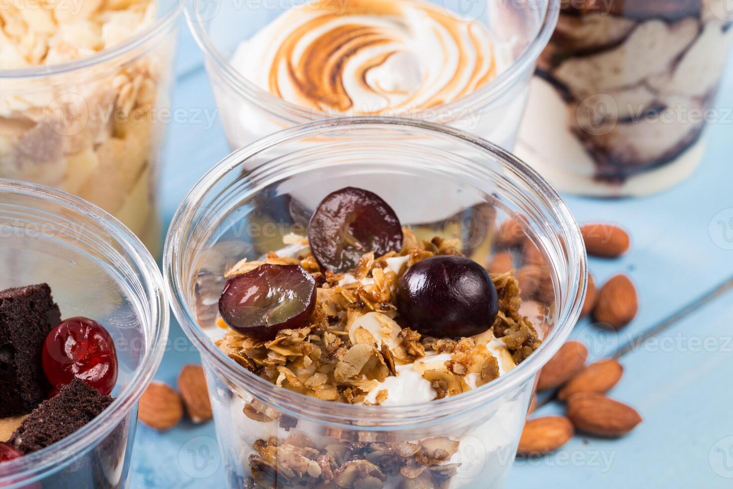 Close up of several desserts in cups photo