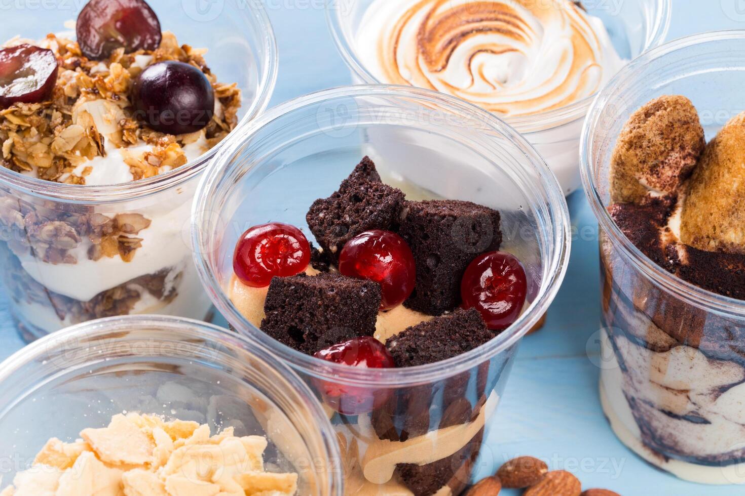 Close up of several desserts in cups photo