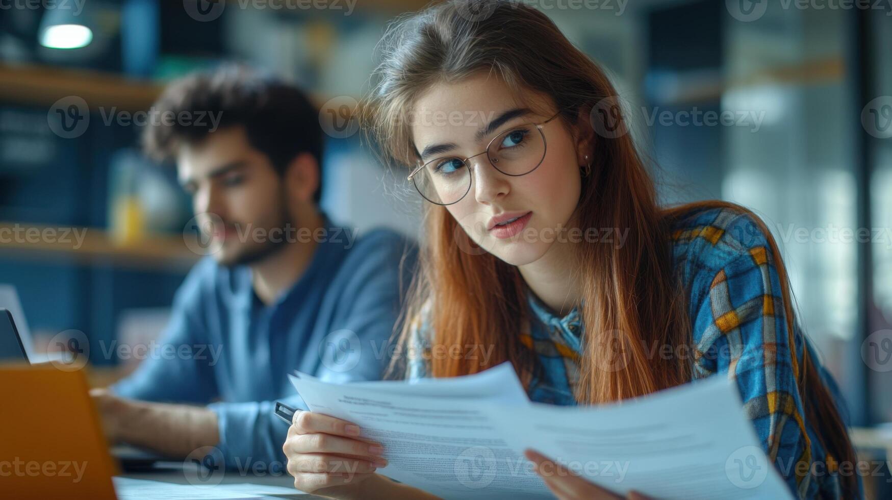 Students work together. Girl looks at document. Boy uses laptop. Desk with paper. Learning and collaboration. Teamwork and study in room. Focused and smart. photo