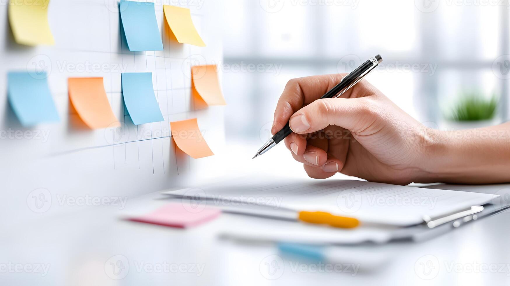 A diverse team brainstorming ideas in office, with one person writing on a whiteboard and others taking notes photo