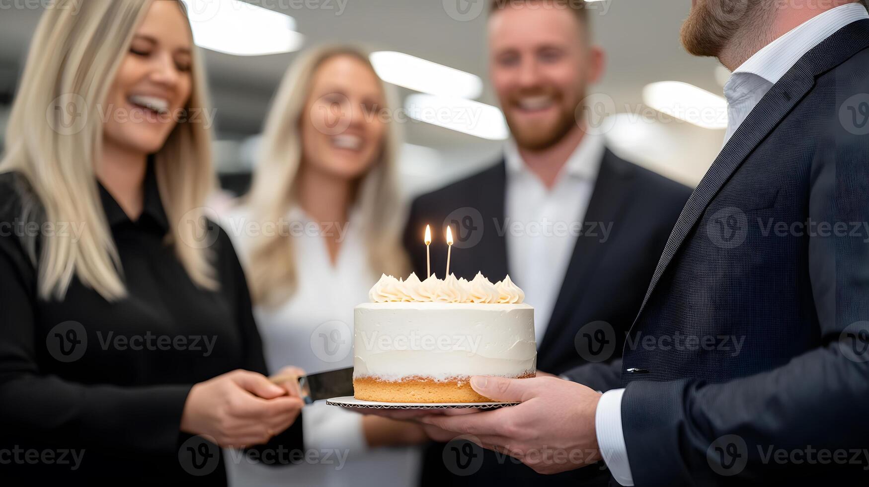 A small cake cutting ceremony in the office, with team members laughing and enjoying a cheerful moment photo