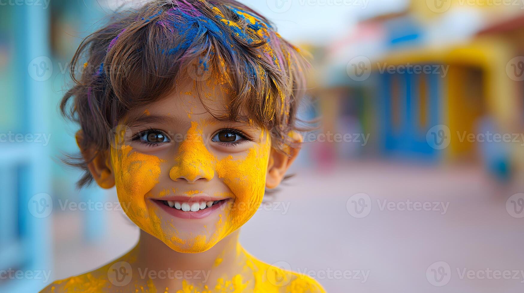 Close-up of a child face covered in bright Holi colors with a big joyful smile. photo