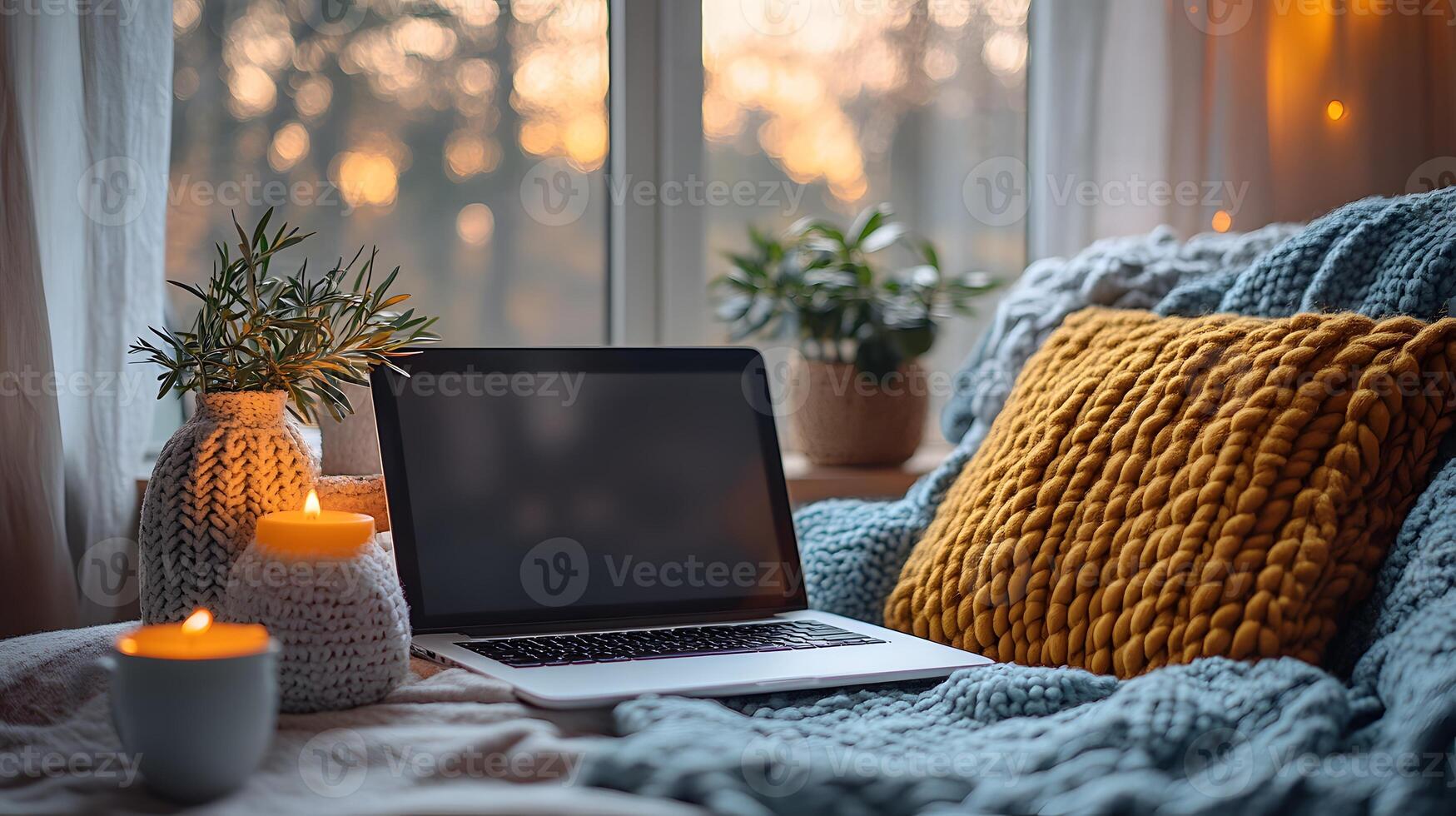 Organized and calming workspace setup with a laptop, small plant, soft textures photo