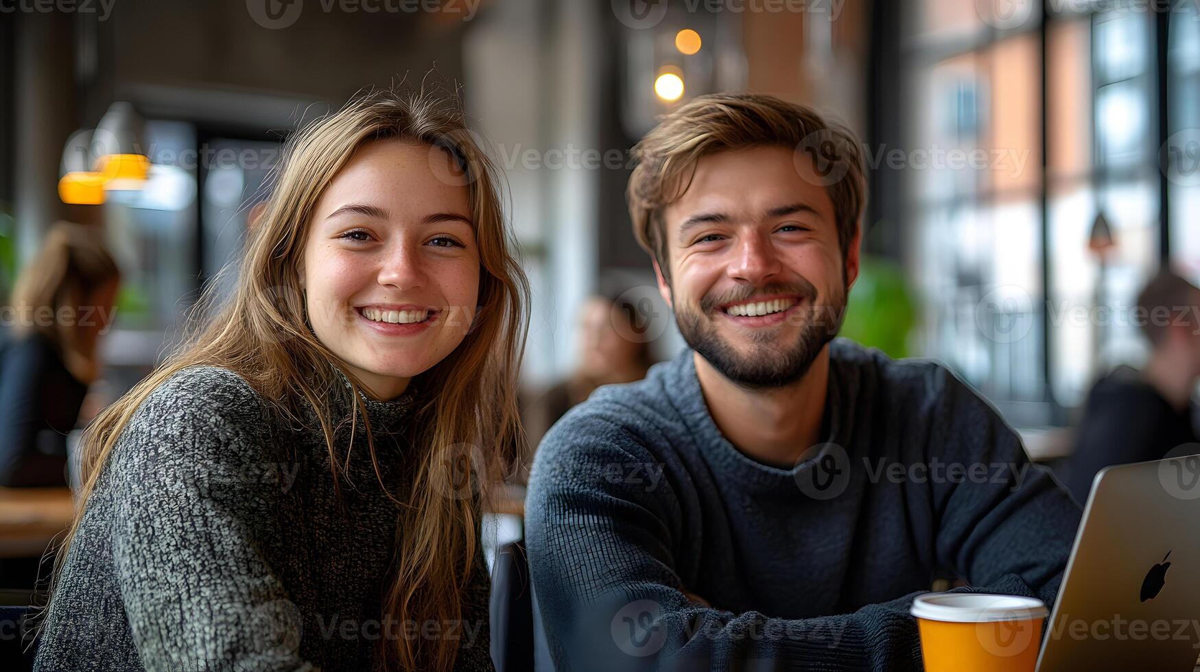 Employees smiling while working together on a project, workplace happiness, successful collaboration. photo