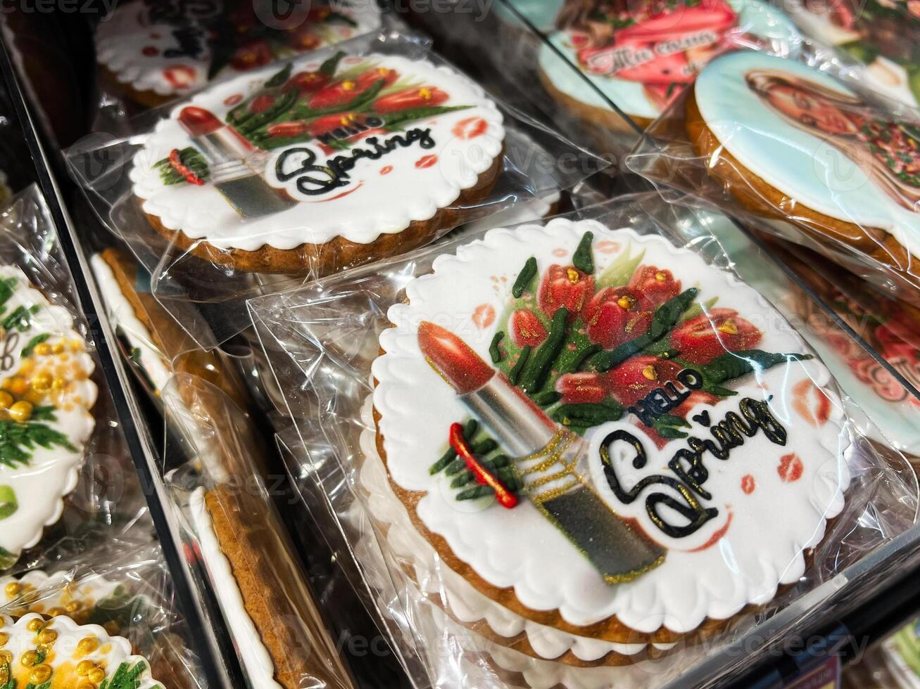 Decorated cookies with spring themes featuring lipstick and flower designs on display photo