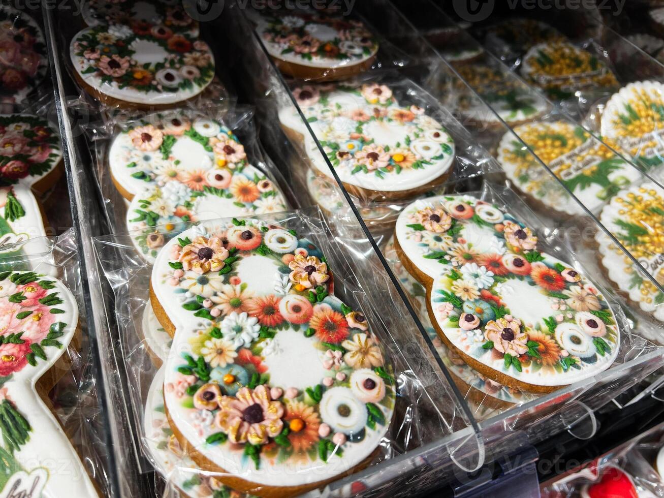 Colorful floral decorated cookies displayed in a store for festive occasions photo