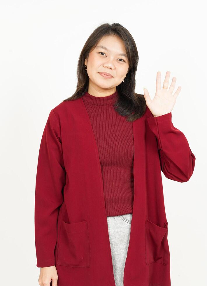 Asian woman in red coat waving her hand photo