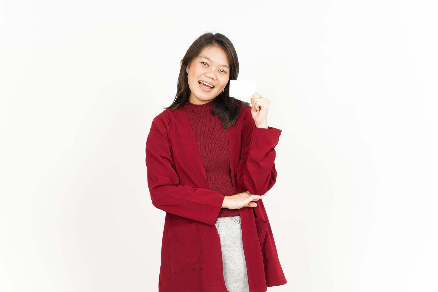 Asian woman in red coat holding up a blank card photo