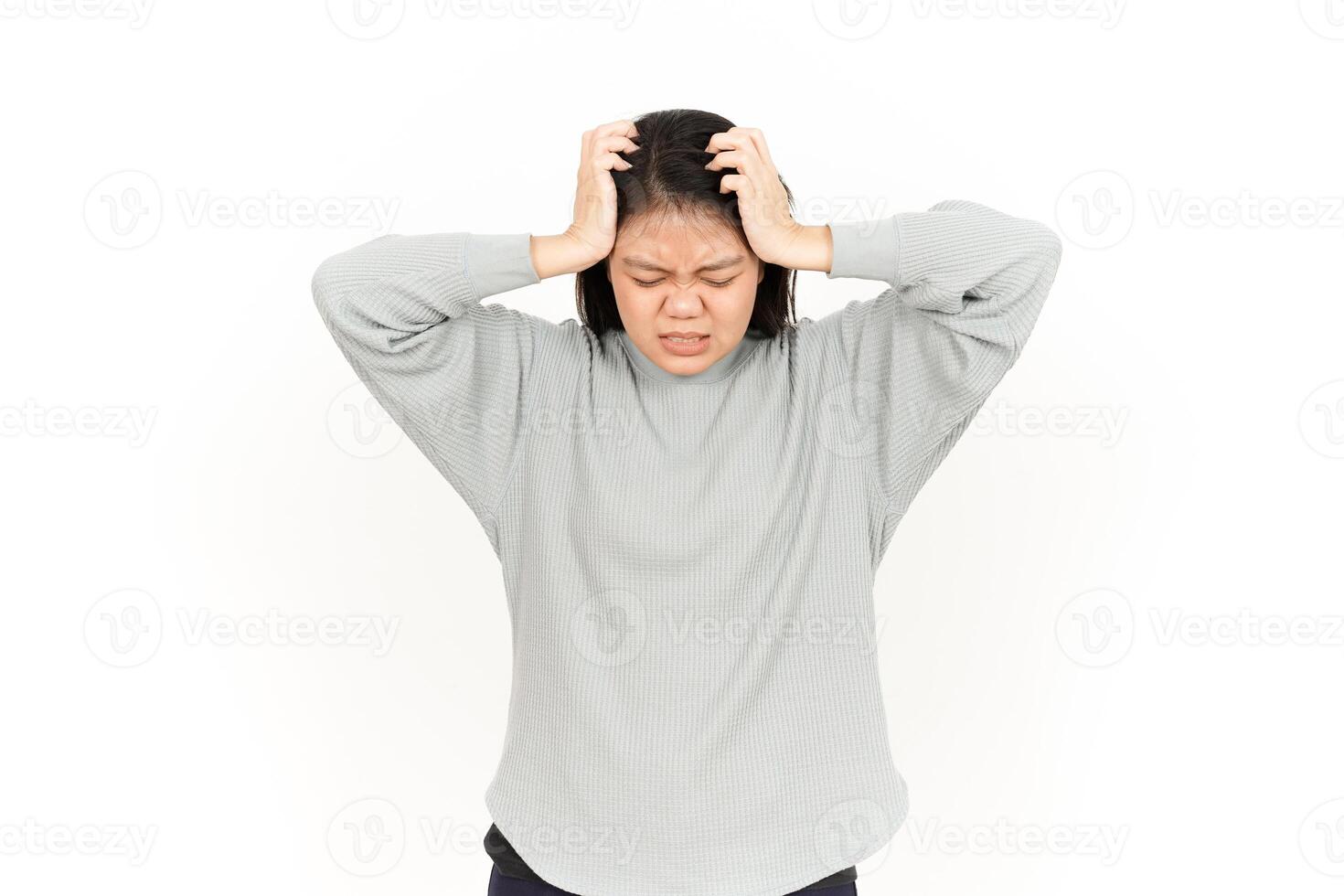 A woman holding her head with both hands photo