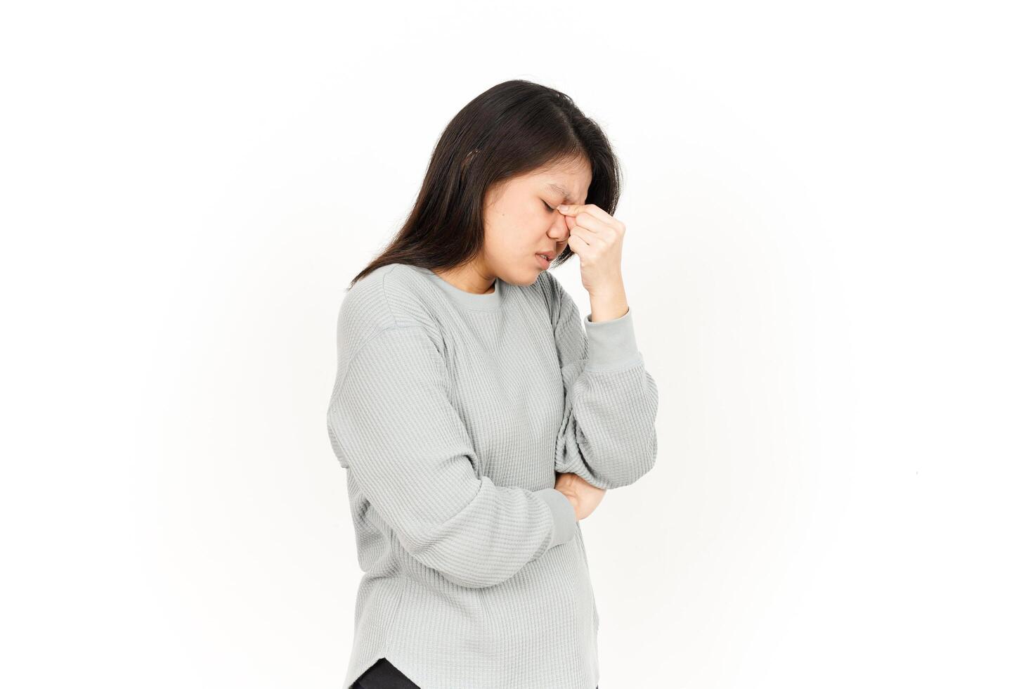 A woman is holding her head while looking down photo