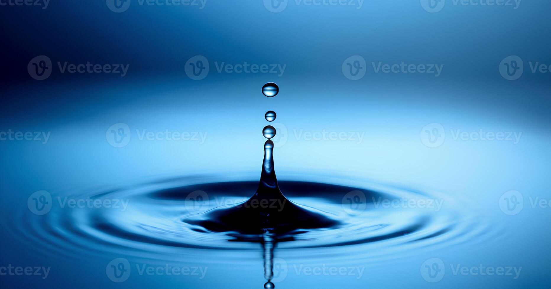 A mesmerizing water drop impacting a tranquil blue surface. photo