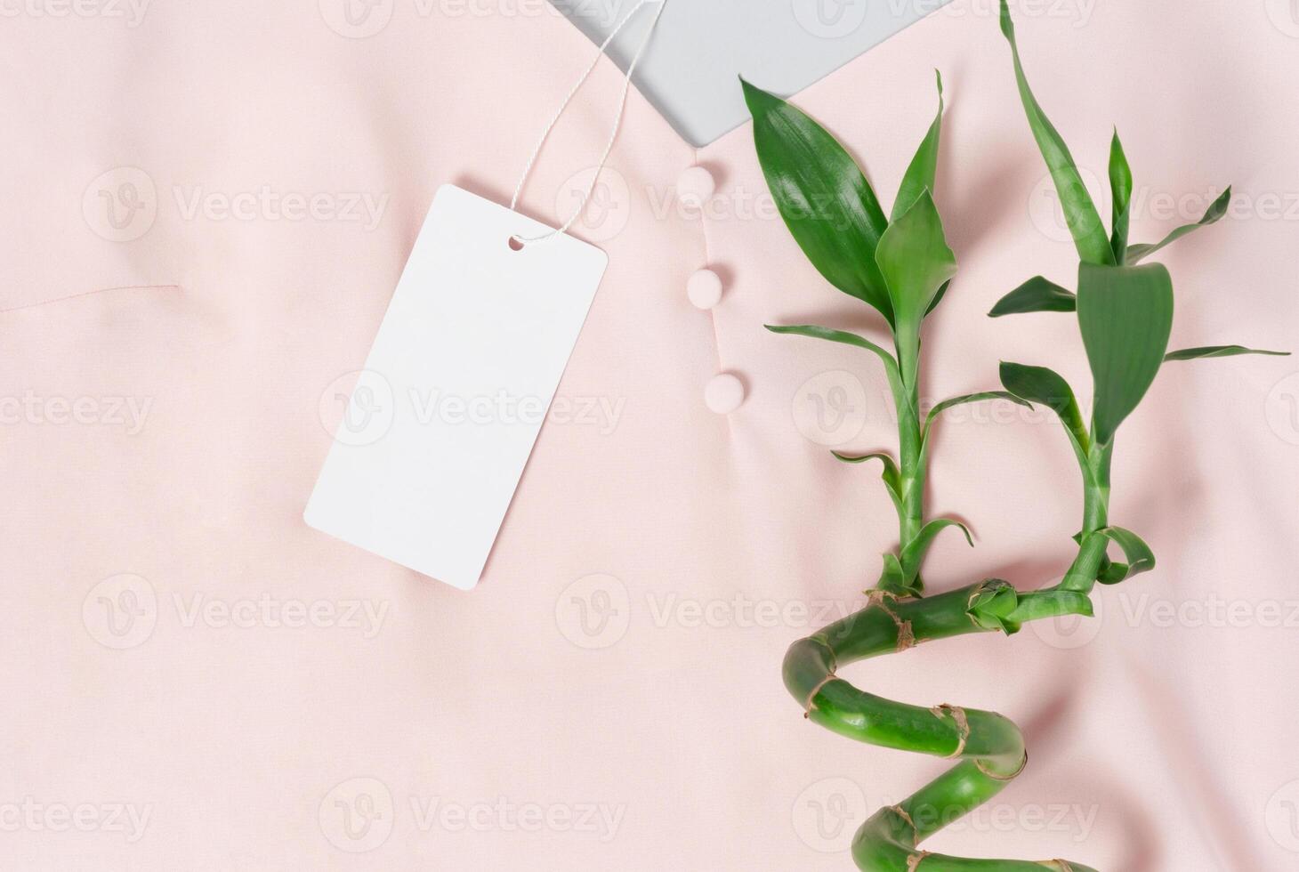 White clothing tag label blank mockup template, to place your design. Premium cotton pink blouse photo