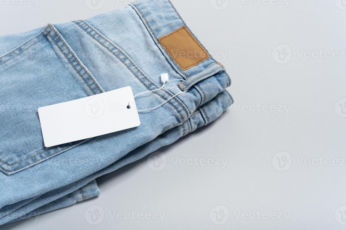 Jeans clothing white paper tag, label blank mockup template, place your design photo