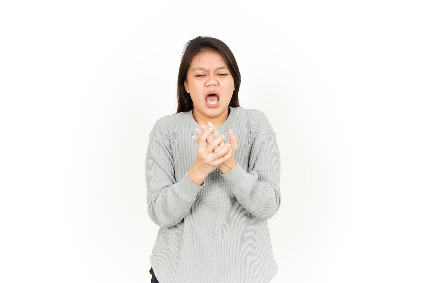 A woman is holding her hands to her mouth photo