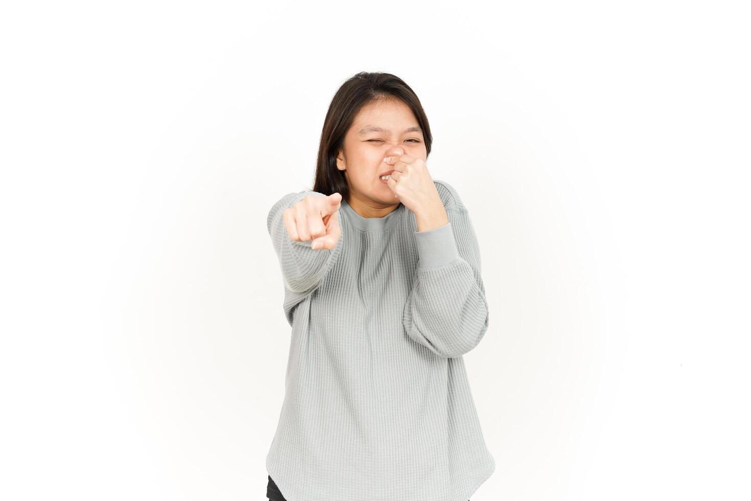 Asian woman with her hand on her mouth and pointing to the side photo