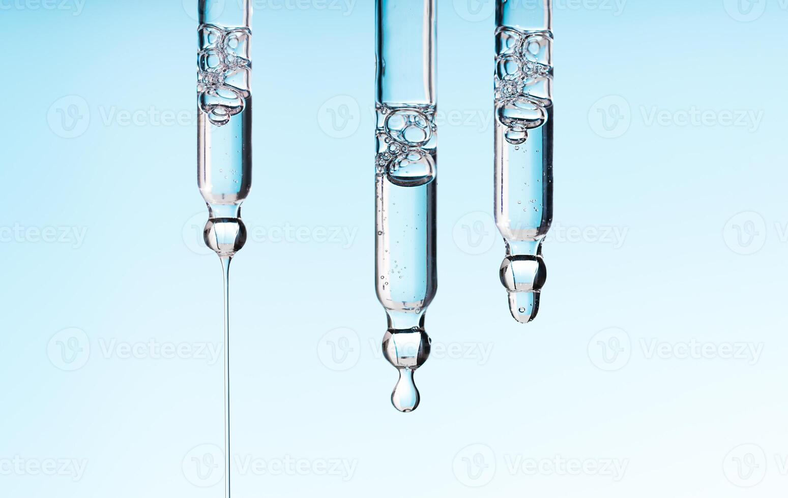 Pipette serum drop with niacinamide, hyaluronic or Aha Bha acids on a blue white isolated background photo