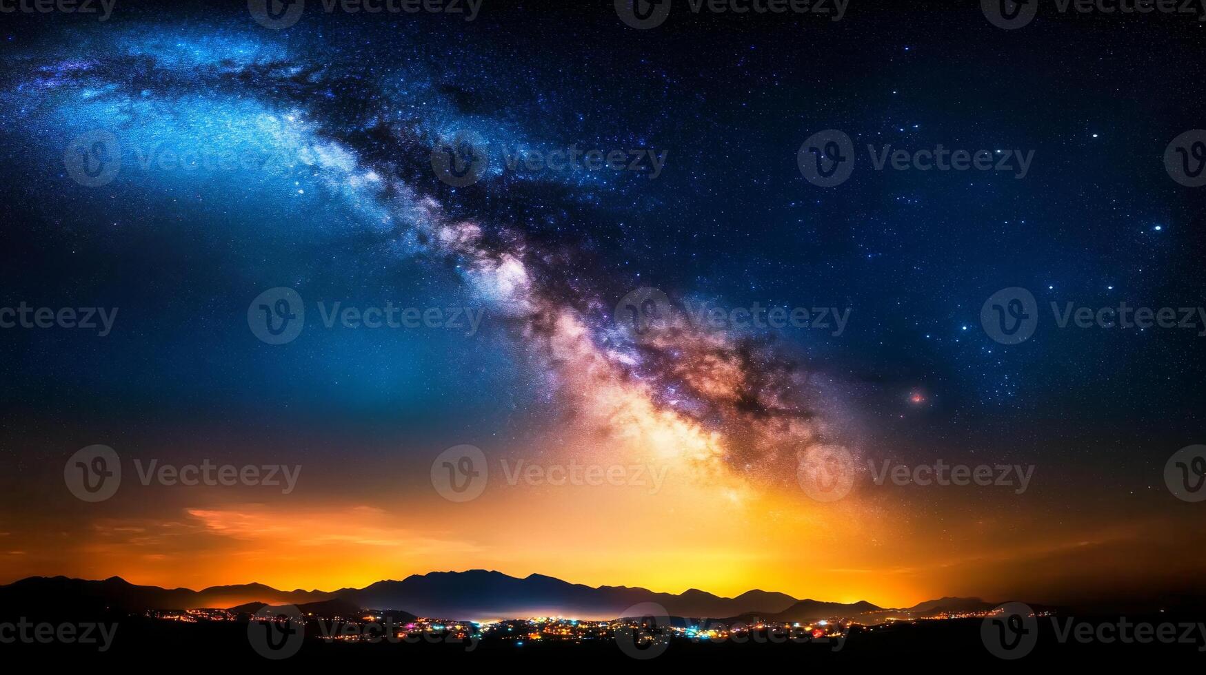 An awe-inspiring display of the Milky Way stretches across the night sky, illuminating a vibrant town in the mountains, creating a mesmerizing contrast. photo