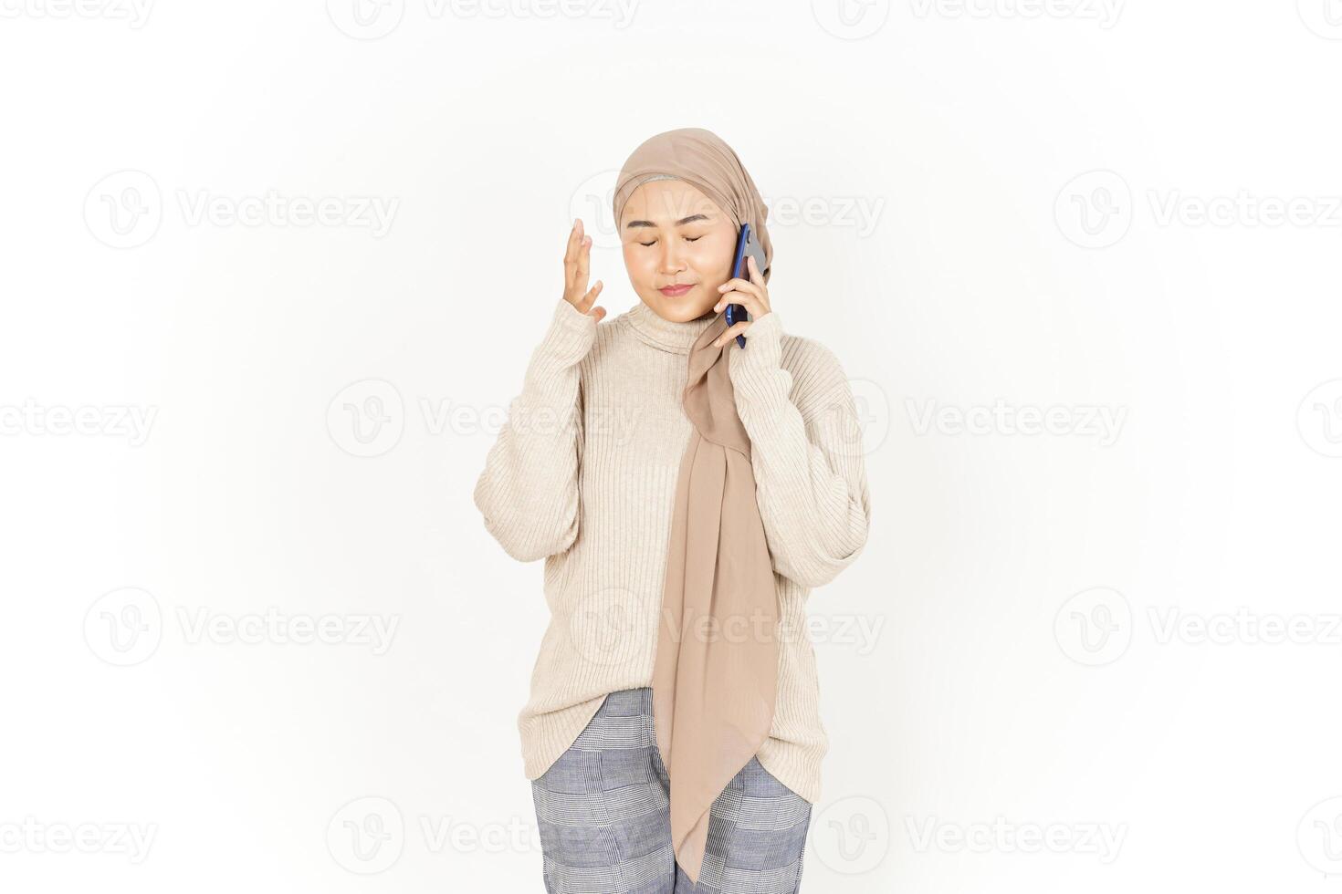 A woman in a hijab is talking on the phone photo