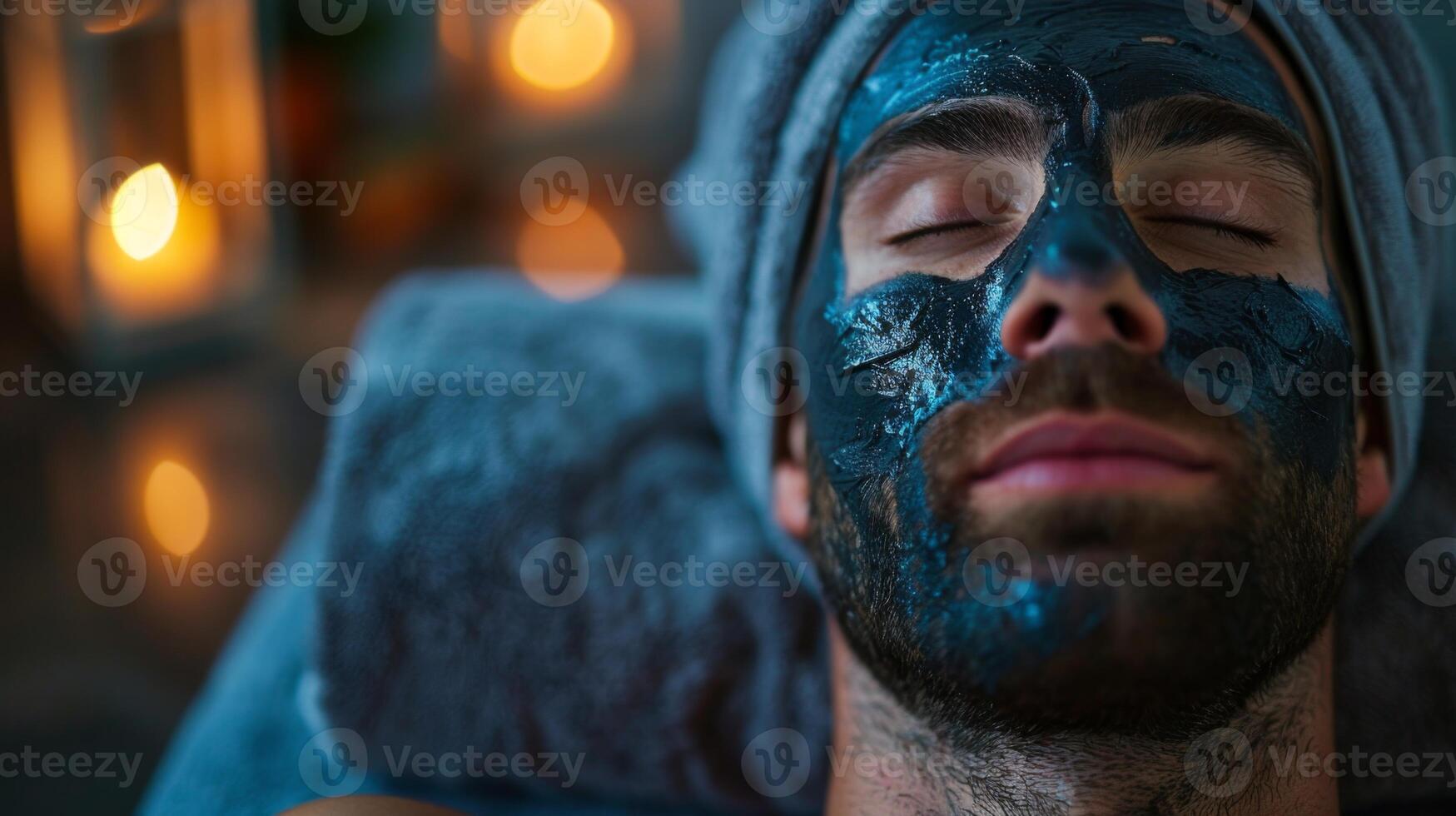 A man relaxes while receiving a beauty treatment at a spa, with a calming face mask applied. Soft candlelight creates a serene atmosphere enhancing his skincare session. photo