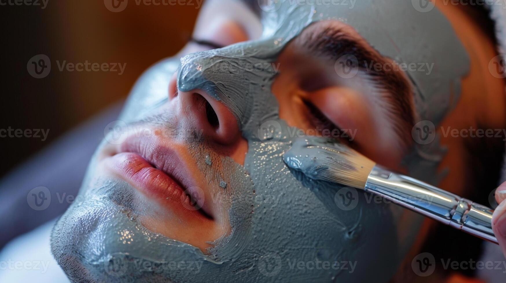 A male client receives a soothing facial mask treatment in a modern beauty salon. The relaxing atmosphere enhances the skincare experience as a professional applies the mask. photo