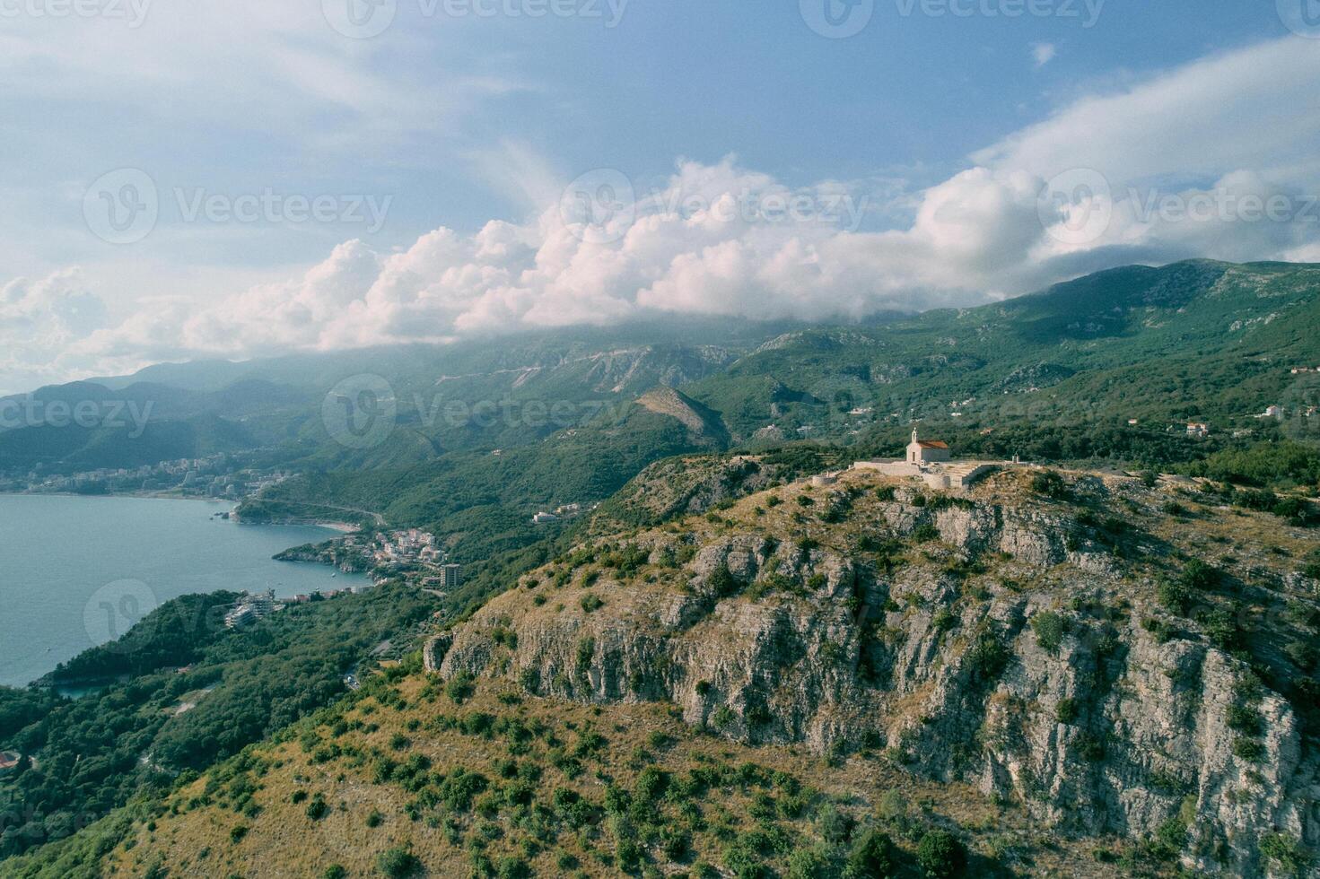 Church of St. Sava at the top of the mountain surrounded by a green mountain range. Montenegro. Drone photo