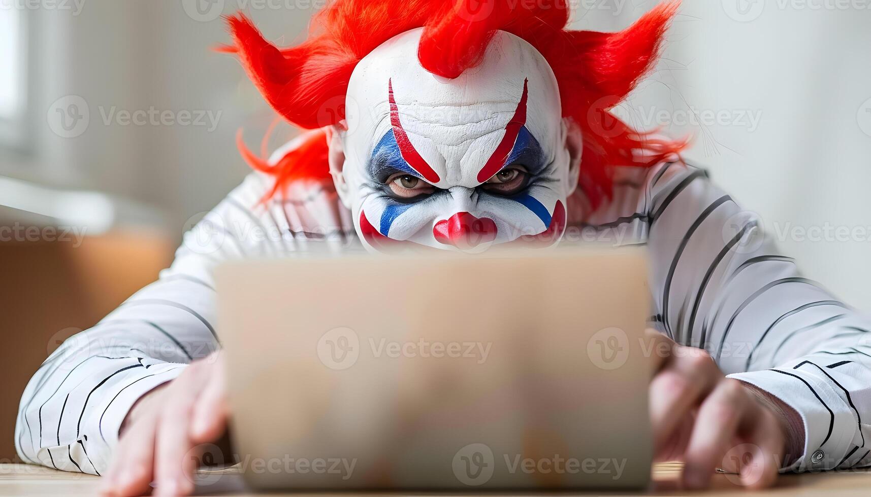 Clown in colorful costume happily typing on laptop at event photo