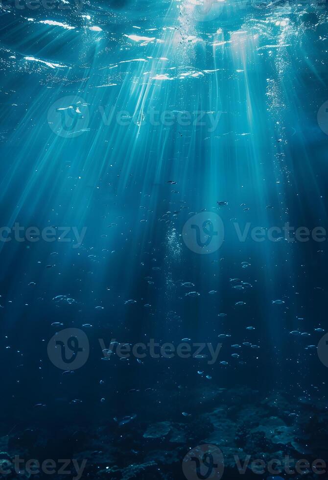 Underwater Light Rays Shining Through Ocean Surface photo