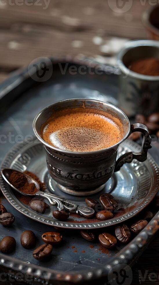 A cup of Cuban espresso served with coffee beans on a tray photo