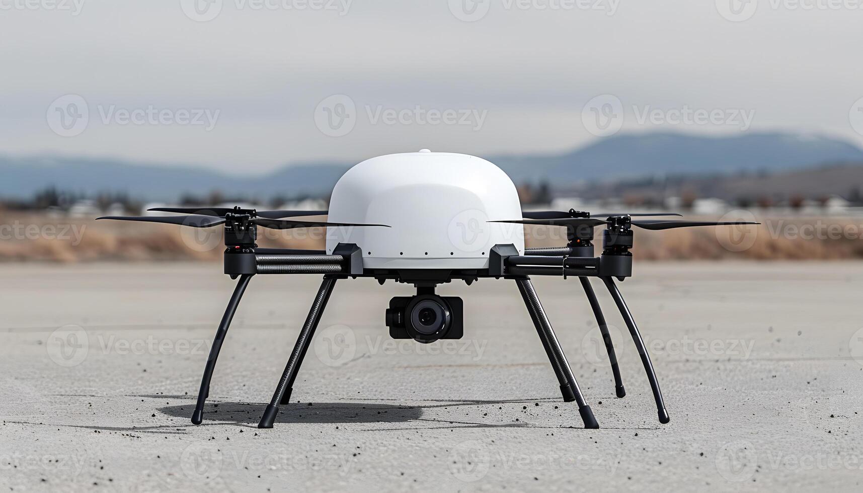 A white drone rests on a concrete surface, under the open sky photo