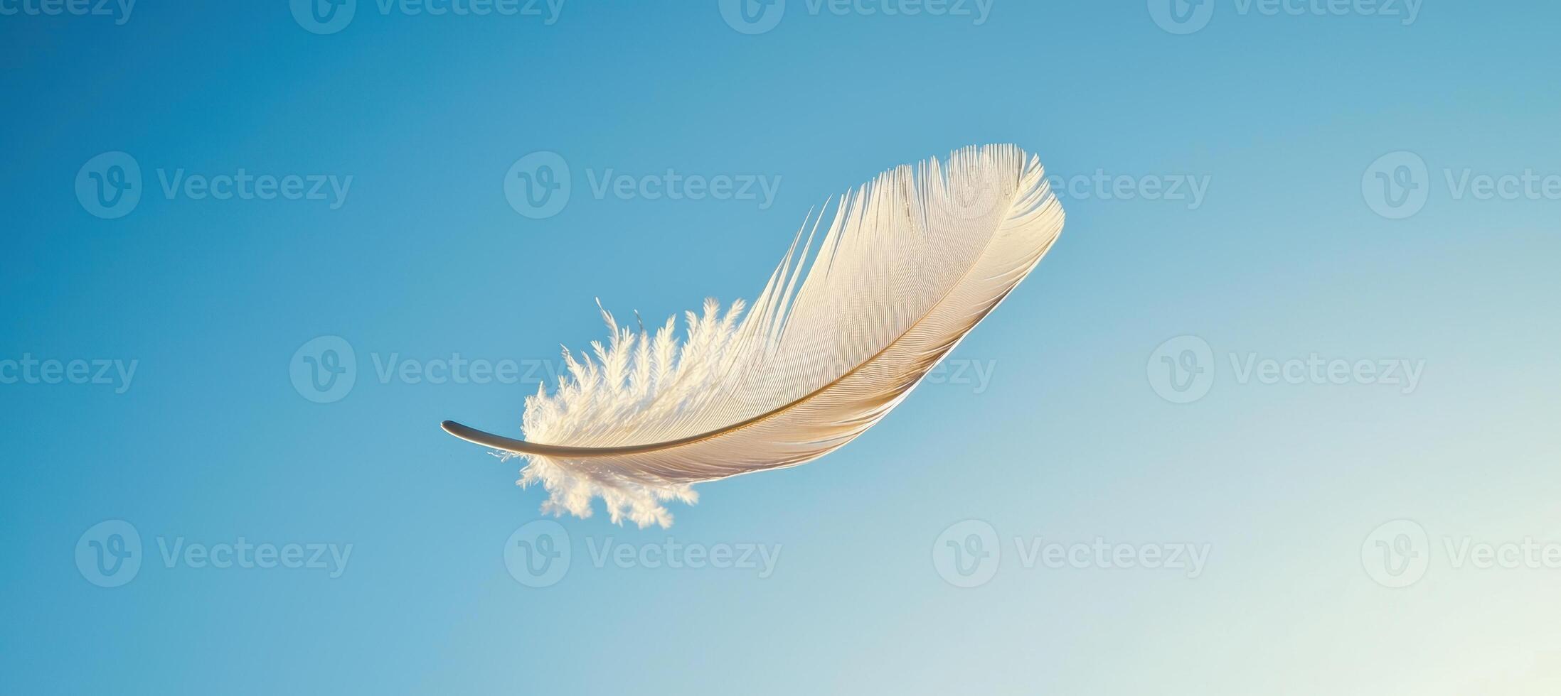 Feather Drifting Gracefully Against Clear Blue Sky - Serenity and Transience Concept for Posters photo