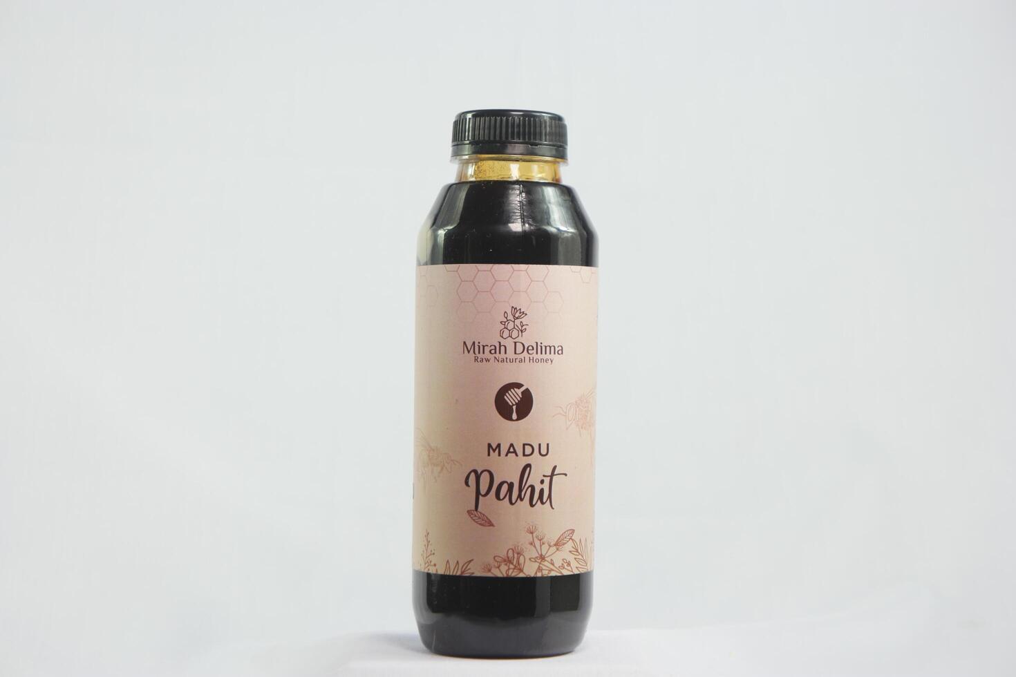 A hands pouring rich golden honey from a bottle onto a fresh lemon slice, emphasizing natural health and wellness benefits photo
