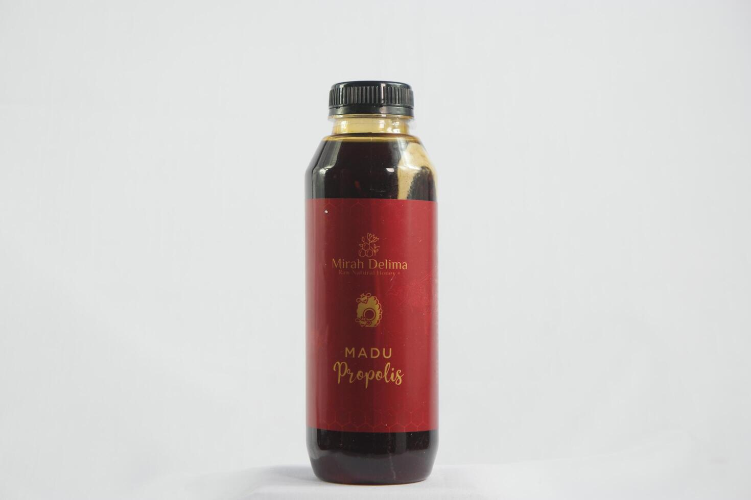 Thick and rich honey cascading from a jar, highlighting its pure texture and golden color, set against a wooden backdrop photo