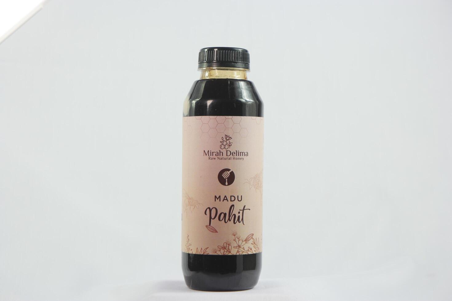 Raw organics honey in a stylish glass bottle, elegantly displayed with beeswax, fresh flowers, and a warm sunlight glow photo