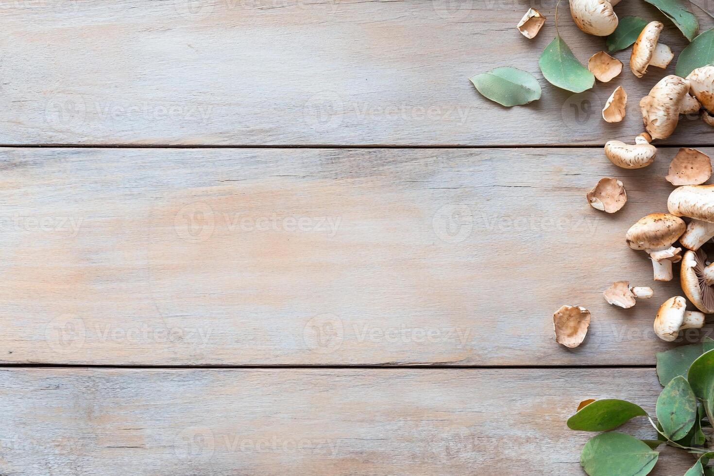Sliced mushrooms and eucalyptus leaves on rustic wood. photo