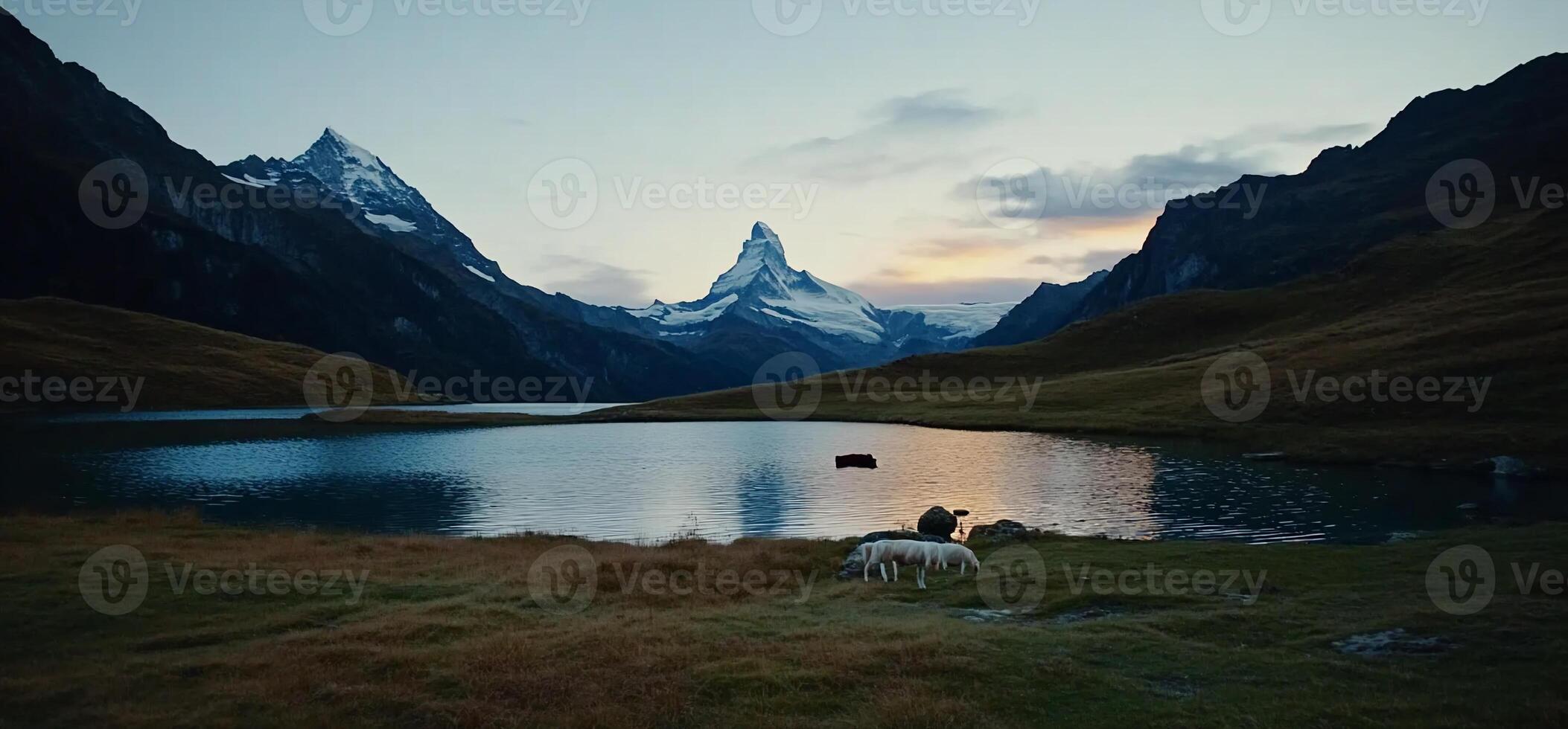 Majestic alpine lake at dawn with snow-capped peak photo