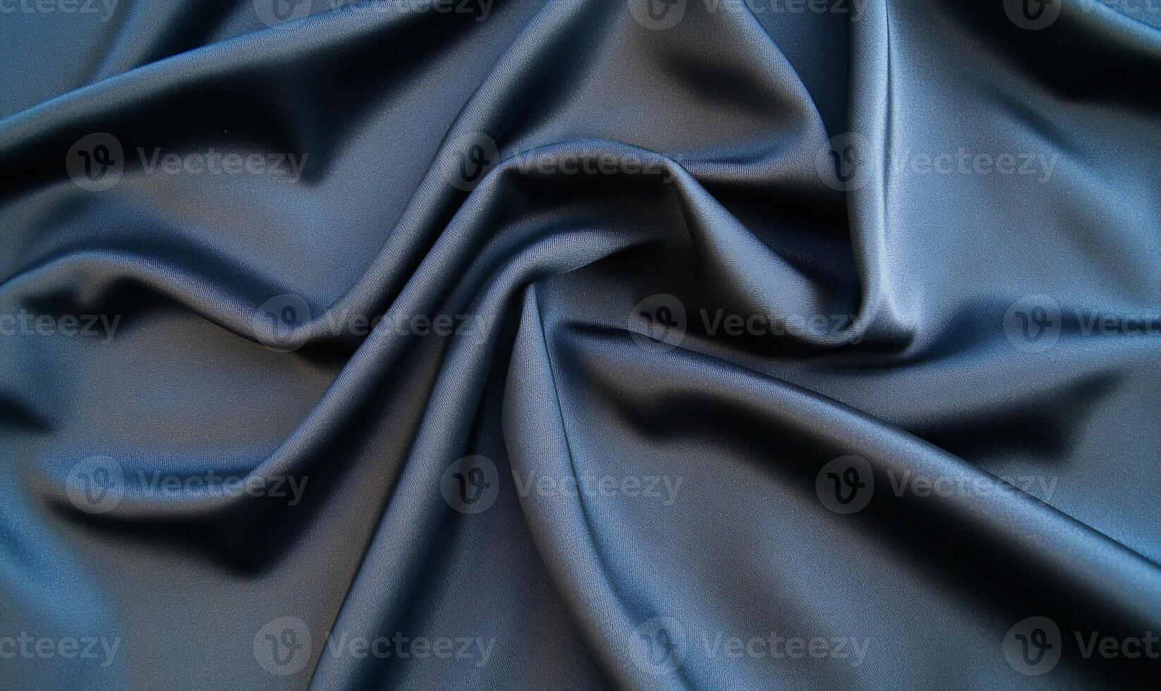 Smooth, draped dark-blue fabric texture. photo