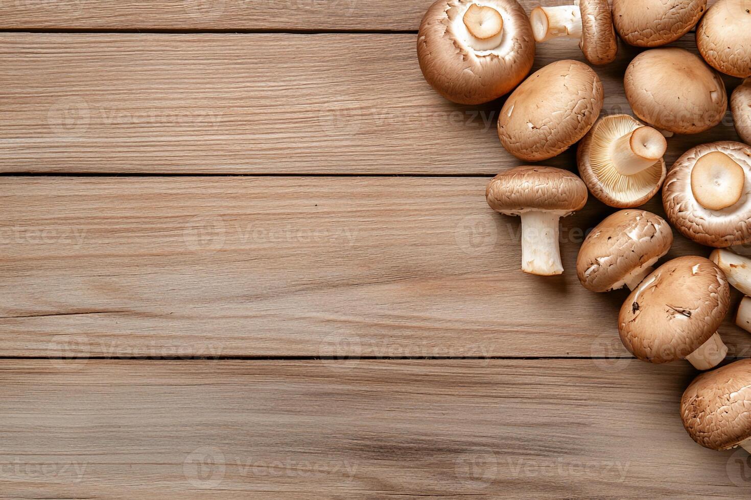 Fresh brown mushrooms on wooden background. photo