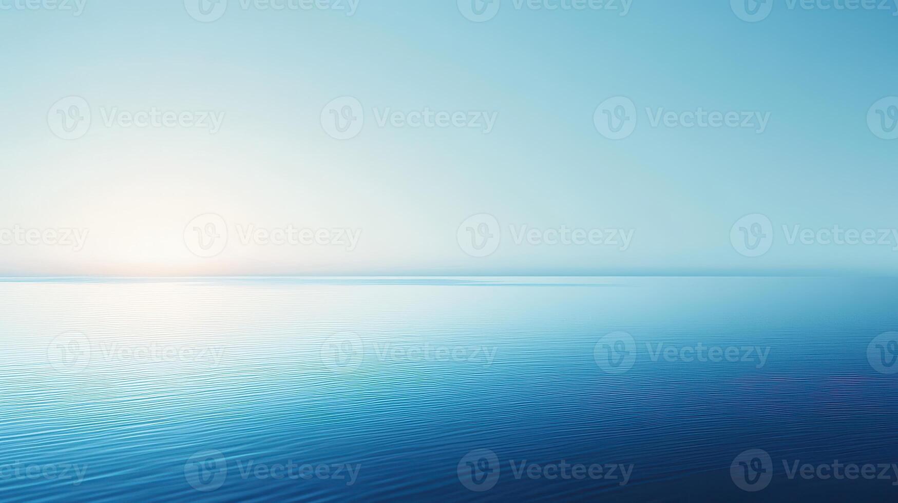 A serene seascape with calm waters and a soft blue gradient sky at sunrise. photo