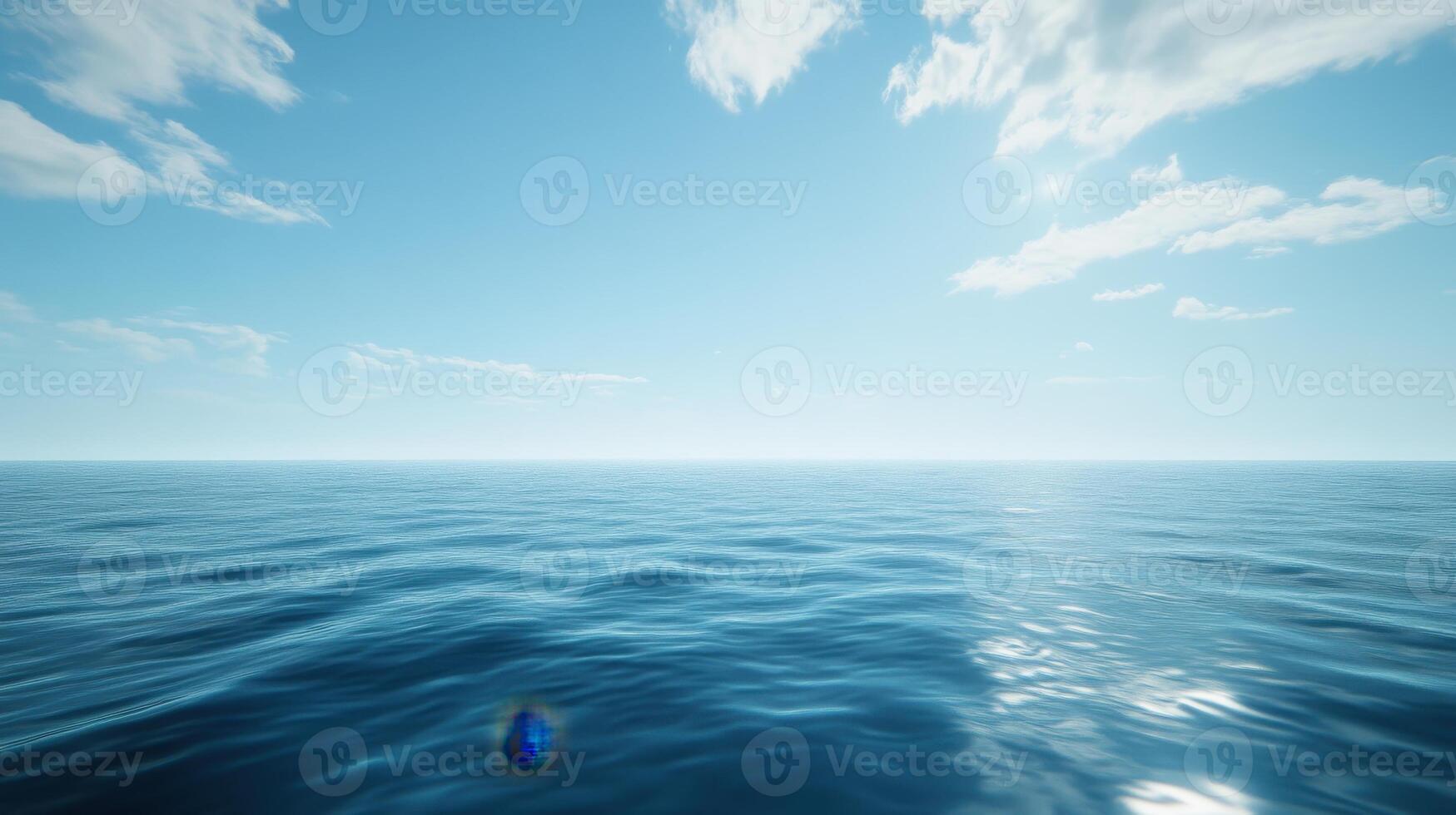 A serene view of a calm ocean under a clear blue sky with scattered clouds. photo