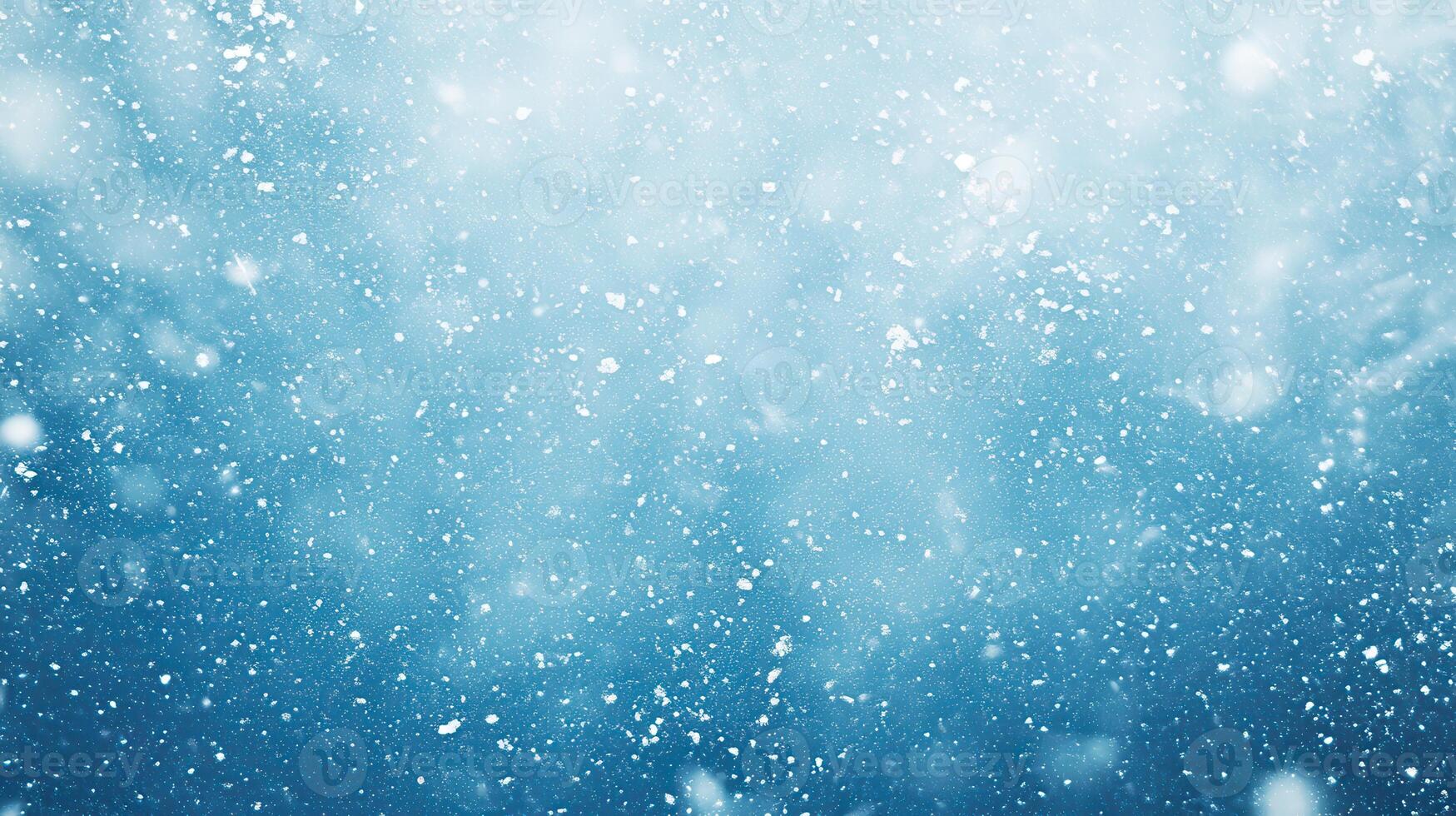 A serene winter scene with snowflakes gently falling against a blue background photo