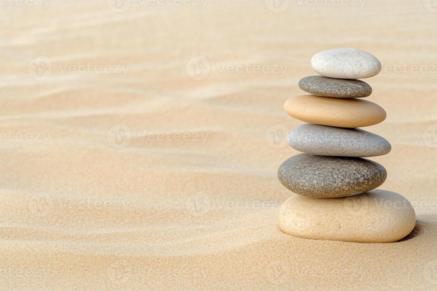 A stack of stones in the sand photo