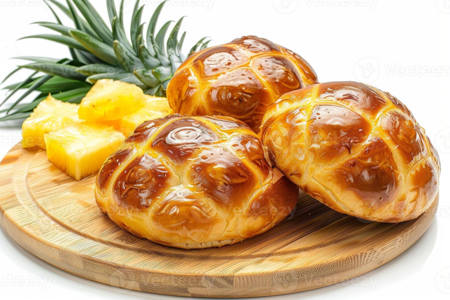 Three golden-brown buns on a wooden board with fresh pineapple slices. photo