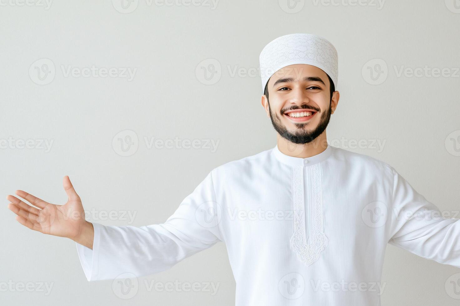 Smiling Muslim man in traditional white thobe with open arms. photo