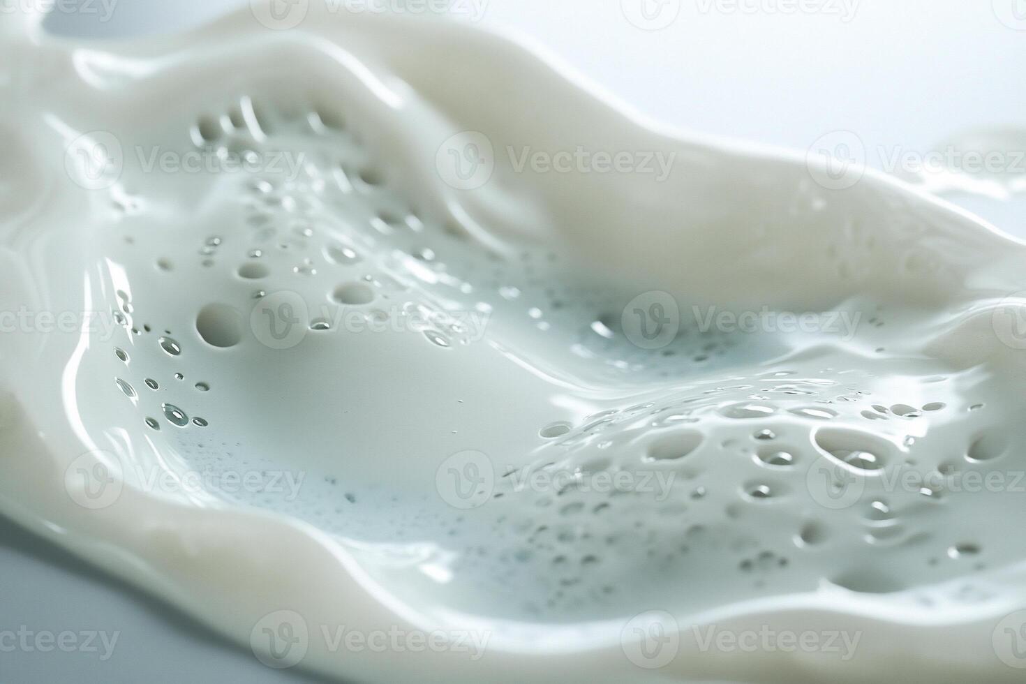 Close-up of creamy liquid with air bubbles, flowing texture. photo