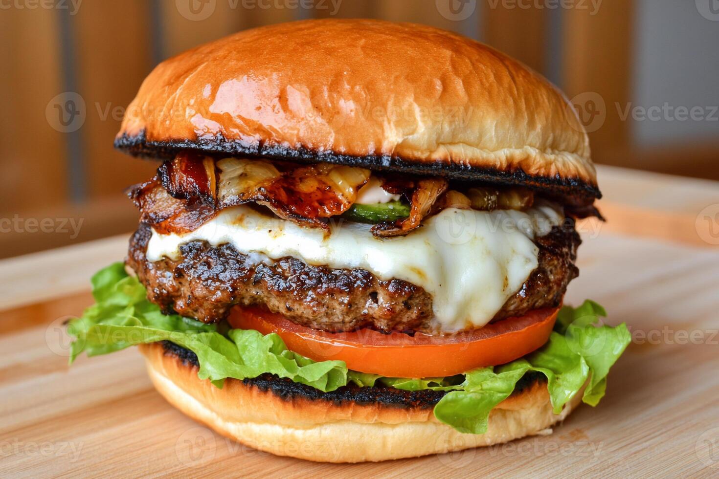 Delicious grilled burger with melted cheese, caramelized onions, and toppings photo