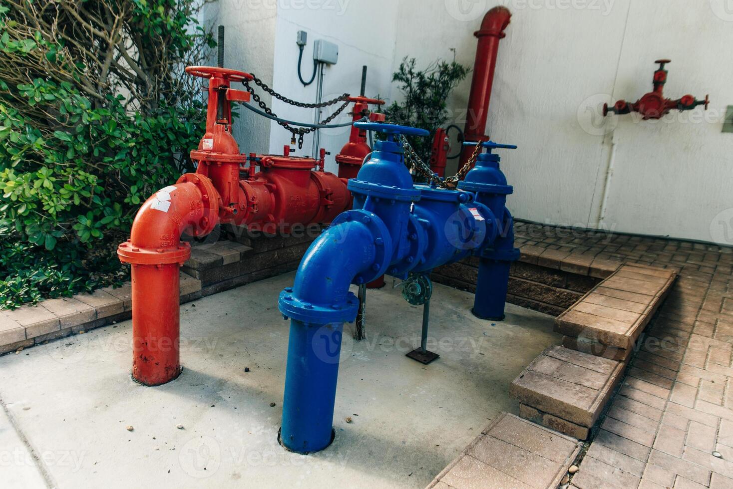 Red and blue iron pipe in the water treatment area. photo