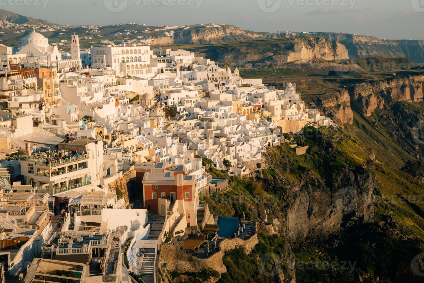 White architecture in Santorini island, Greece. Beautiful view of Oia town at sunset photo