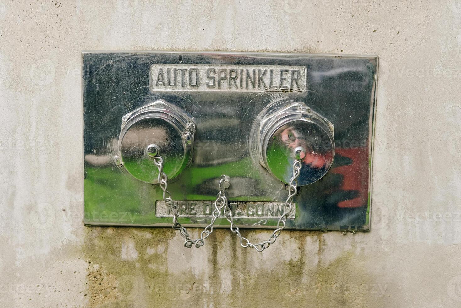 canada, vancouver - november, 2019 Fire silver hydrant in the wall. Steel fire hydrant in the concrete wall photo