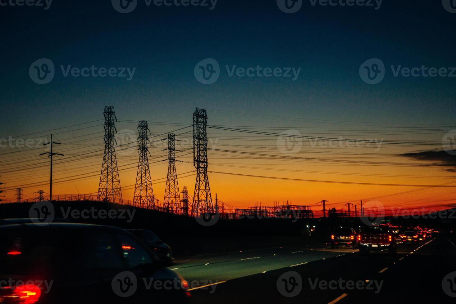 Electric transmission lines against a background of sunset over mountains. photo