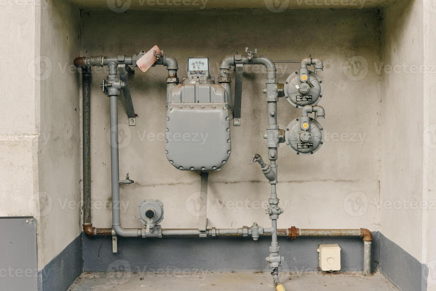Heating system. Instalaltion of water pipes on the grey concrete wall. Plumbing connection. Repair bathroom in house.. photo